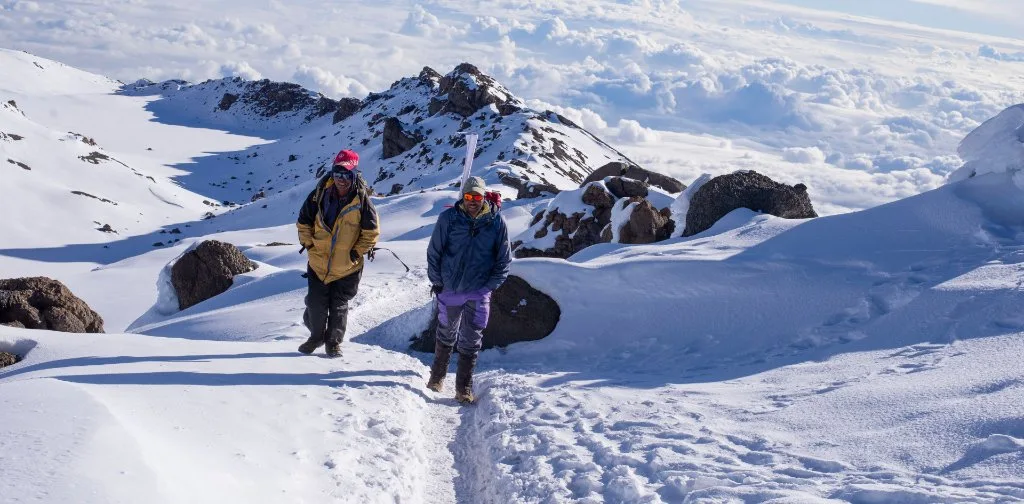 Climbers crossing a snow-covered mountain slope