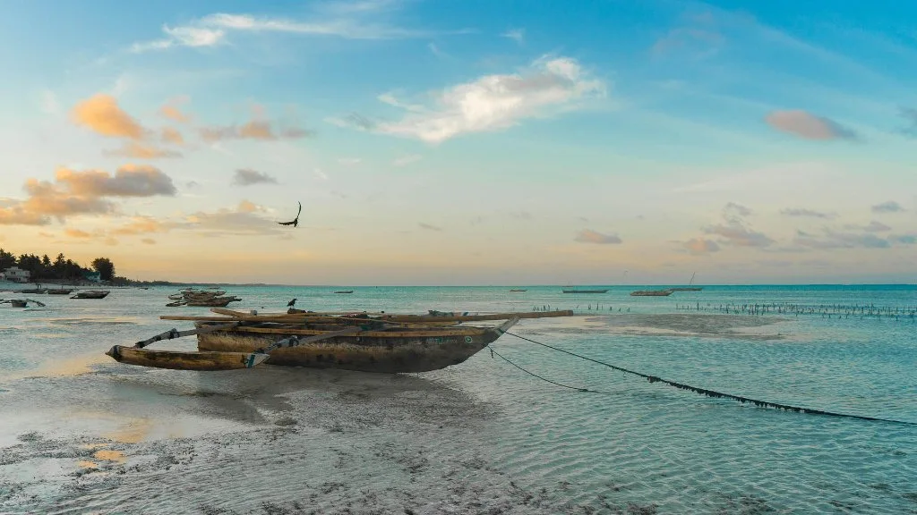 A wooden boat in shallow coastal water