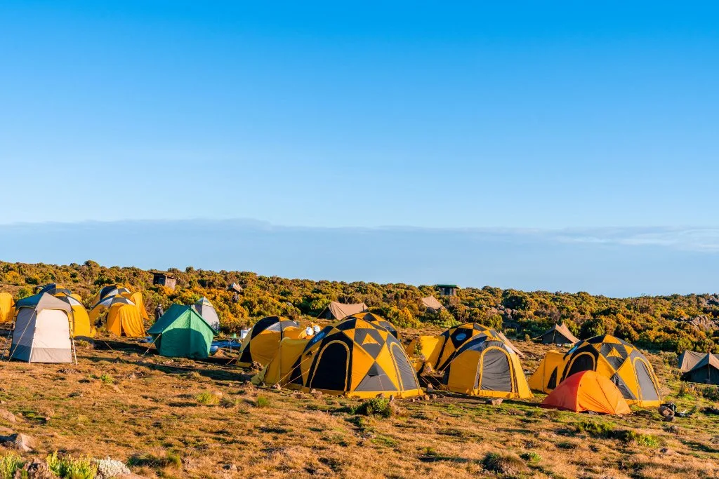 Mountain tents under clear blue skies