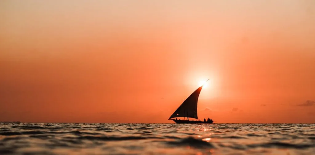 A dhow silhouetted against sunset